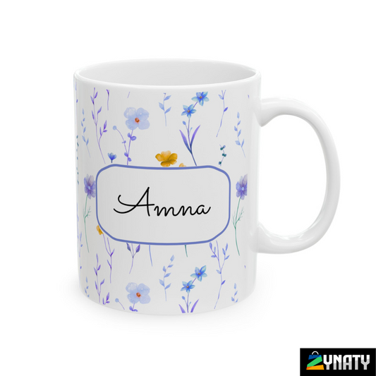 A white ceramic mug with a floral pattern and the name 'Anna' printed on the front.
